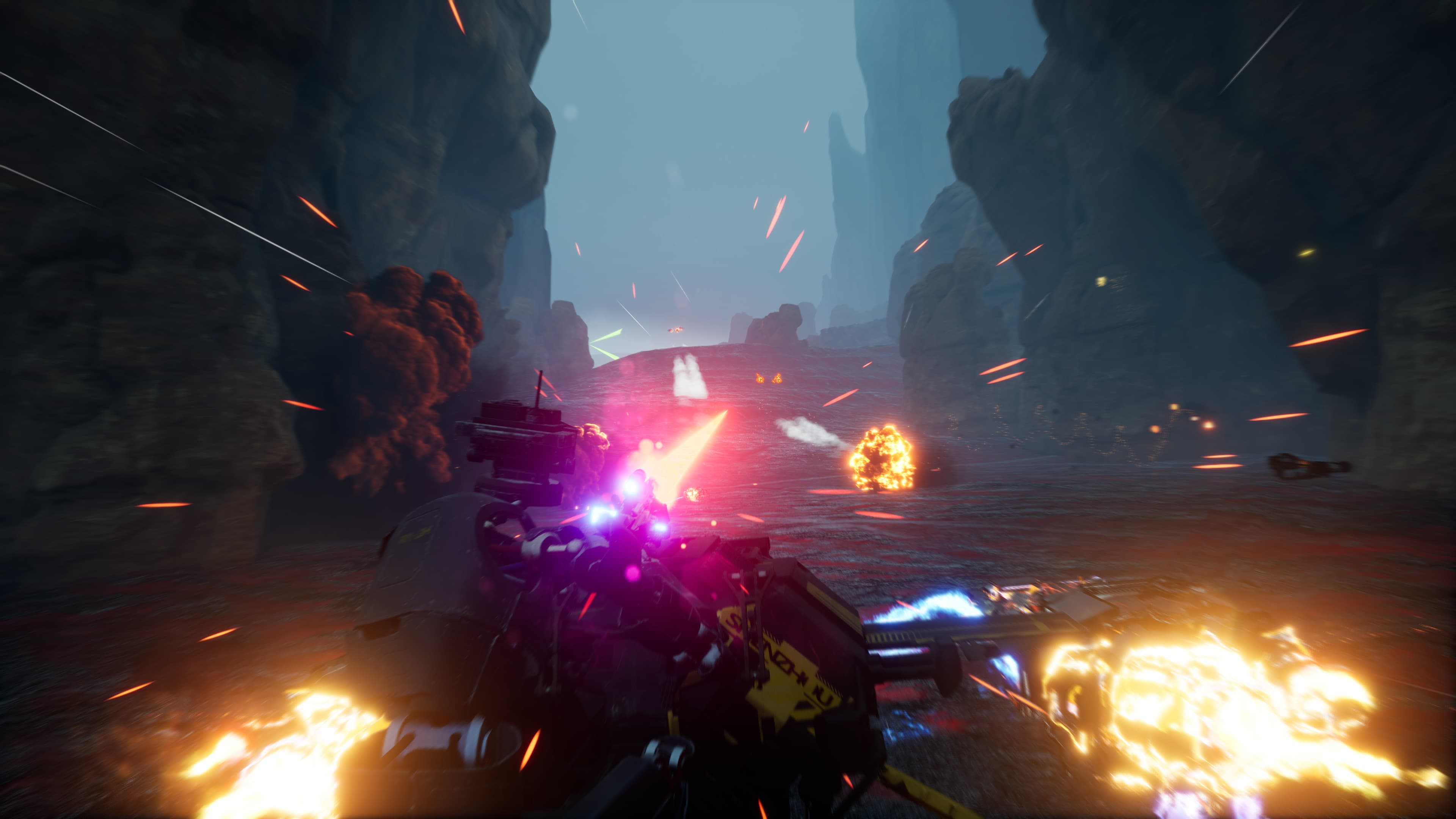 A combat racer firing through explosions in a narrow rocky canyon.